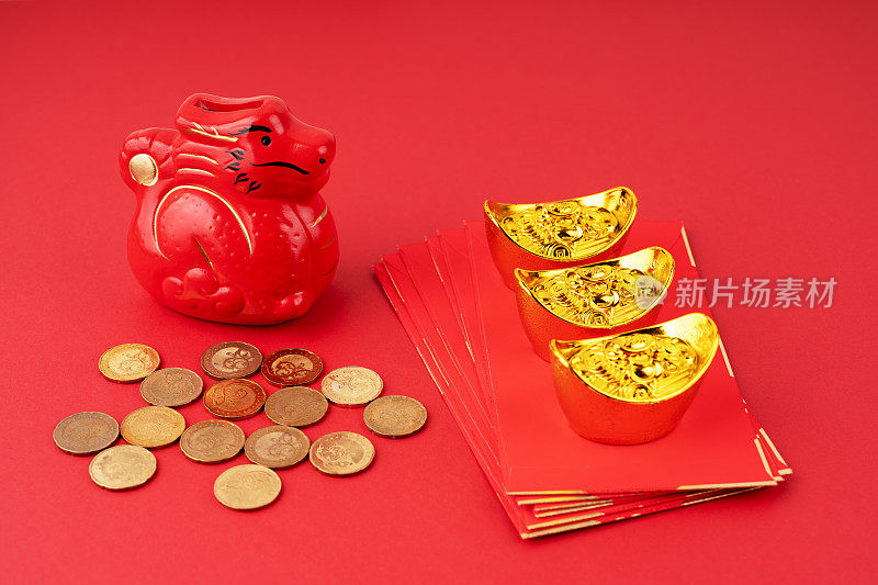 Year of the Dragon with red envelope and gold ingot and coins